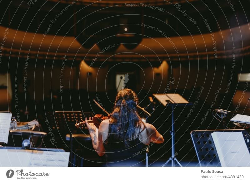 Rear view girl playing violin Violin Detail Violinist Concert soloist Audience Listen to music Colour photo Stage String instrument Orchestra Art Classical