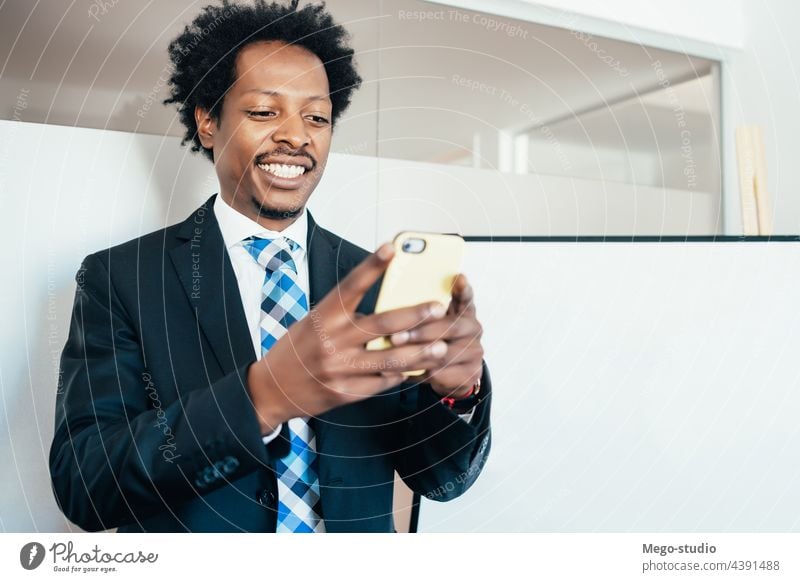 Businessman using his mobile phone. businessman office workplace people portrait worker messages job break working connection joyful holding employee indoors