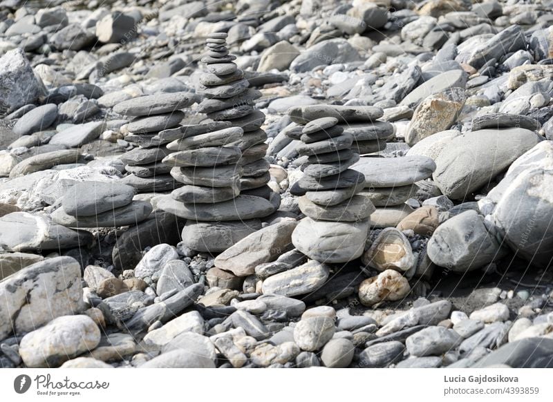 Stone towers  or stone cairns. They are placed on the rocky river bank of Rhine in Switzerland. abstract arrangement balance calm closeup concentration concept