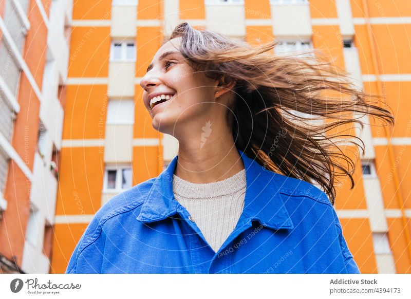Happy woman standing in city and laughing bright color having fun urban cheerful street vivid female delight carefree style glad optimist happy excited content