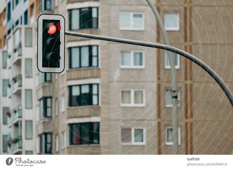 Red traffic light in front of a drab exterior facade of a 70s apartment building Traffic light red traffic light Architecture Apartment Building Balconies Dark