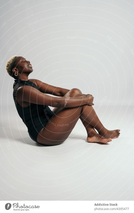 Determined black woman in bodysuit in studio determine body positive shape curve confident accept female ethnic african american figure underwear style feminine