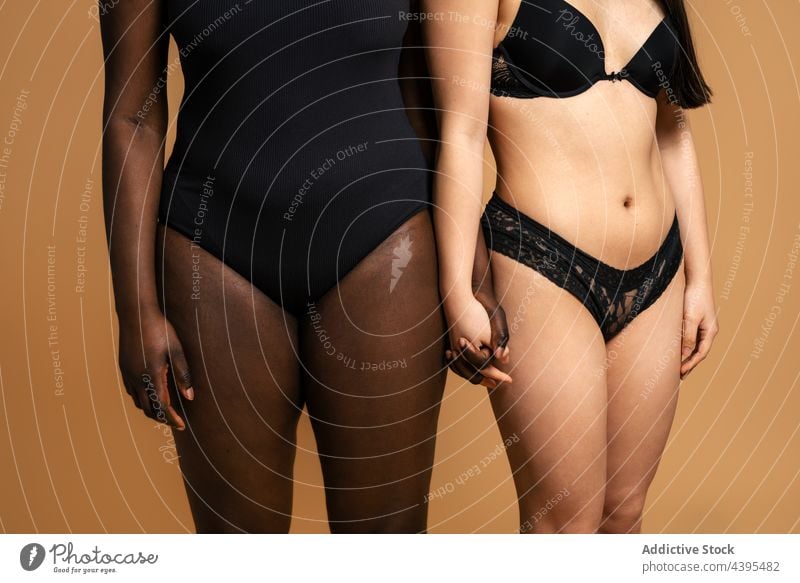 Crop diverse women in lingerie holding hands body positive studio underwear accept together figure multiracial multiethnic female black african american