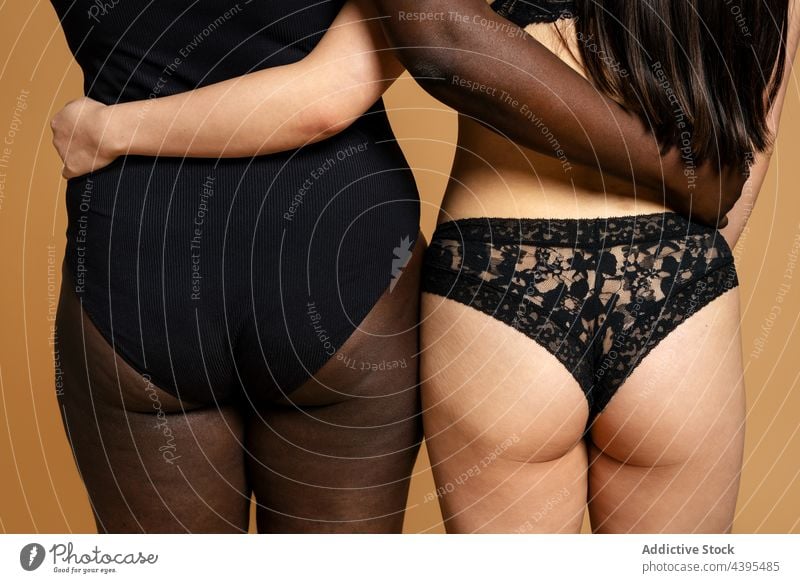 Multiracial women in underwear embracing in studio body positive embrace hug accept together lingerie figure diverse multiracial multiethnic female black