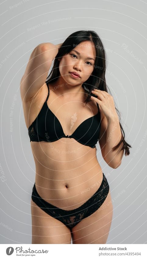 Asian woman in underwear in studio body positive lingerie confident accept appearance figure female asian ethnic bra panties complexion calm serene determine
