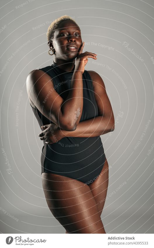 Woman with her hands over her face woman bodysuit body positive curve shape delight female ethnic african american black optimist glad content short hair blonde