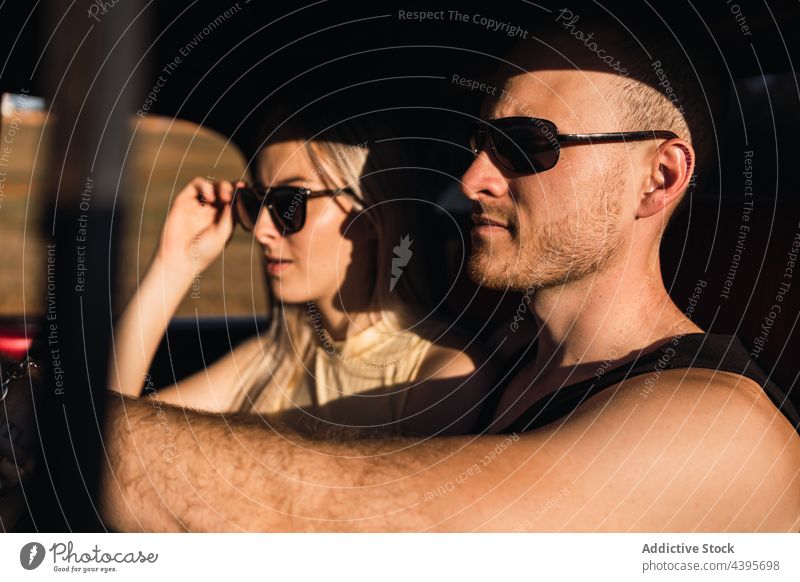 Couple sitting together in car on sunny day couple cool automobile content sunglasses vehicle brutal confident girlfriend boyfriend relationship summer