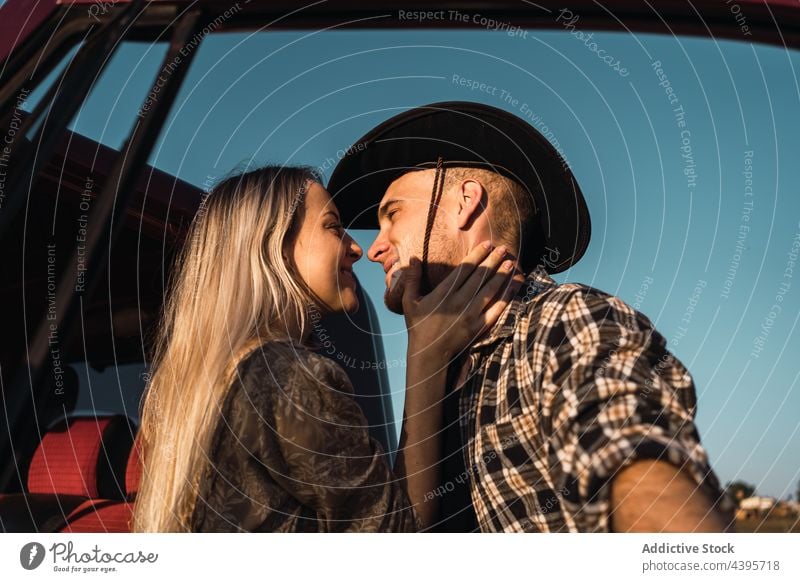 Couple in love kissing near car couple blue sky romantic evening summer relationship together affection cowboy tender young freedom bonding close boyfriend
