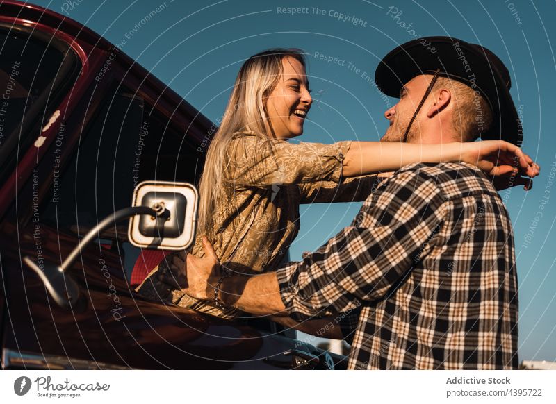 Happy couple embracing near retro car hug vintage window love countryside happy old fashioned sunset relationship affection evening smile together girlfriend