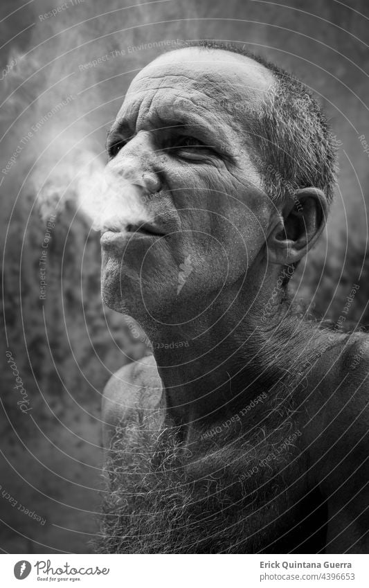 Old man smoking cigarettes Black and white portrait smoke tabacco Nicotine Unhealthy Addiction cigarette dependence Harmful to health Health hazard