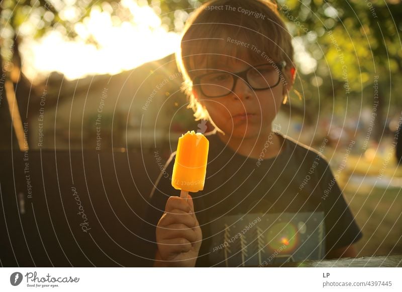 boy eating icecream and looking like he is thinking about something Looking Questioning Resting discovering detect spot perceive Notice Wait Demand Request