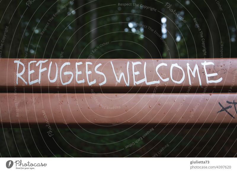 Refugees welcome | Lettering on a bench Graffiti Exterior shot Park Bench writing Characters Deserted Humanity human Welcome Colour photo Hospitality