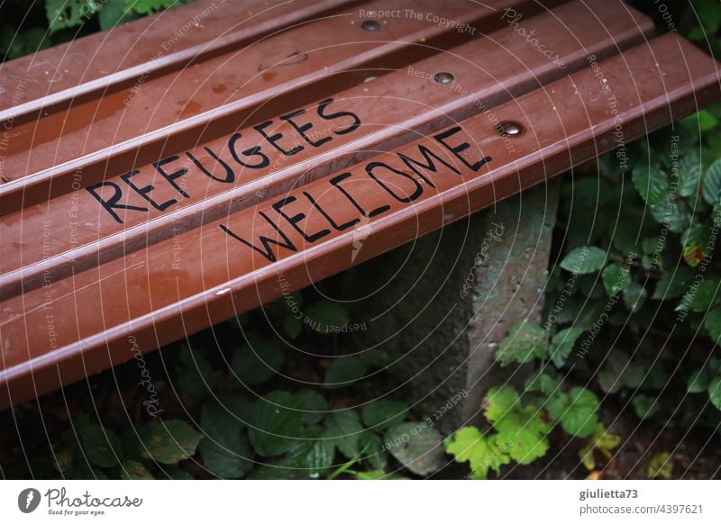 Refugees welcome | Lettering on a bench Graffiti Welcome writing Bench Park Exterior shot Characters Deserted Colour photo refugees welcome Hospitality
