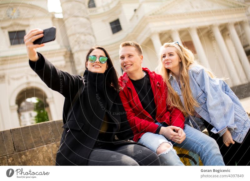 Young people taking selfie with mobile phone in Vienna, Austria ancient baroque beautiful camera city destination europe european female friends happy historic