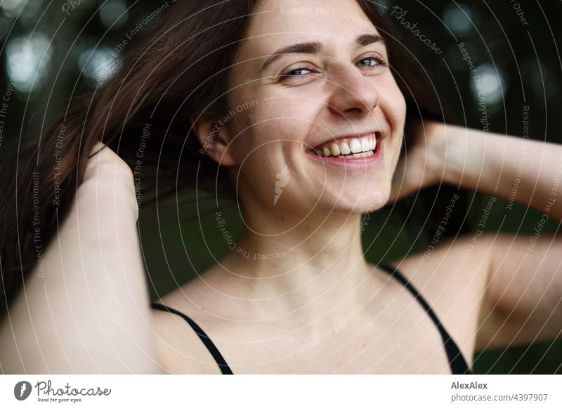 Young woman with dimples holds her hands to her side and smiles Nature Brunette Athletic 18 - 30 years Adults Long-haired Esthetic Youth (Young adults) Identity
