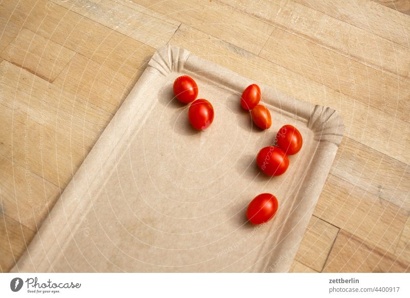 Seven small tomatoes on grey paper plate Tomato Harvest Fresh fruit Vegetable Plate paper plates Table Wooden table sieving Red Cocktail tomato Copy Space