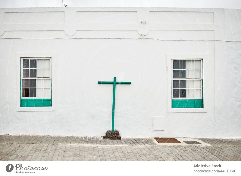 Green cross outside white building church street religion exterior pavement architecture town culture fuerteventura spain canary islands structure facade green
