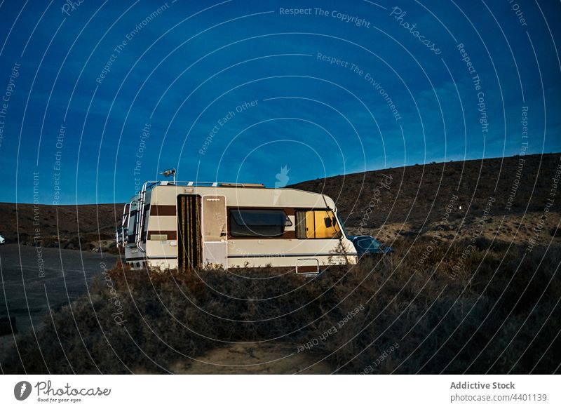 Retro RV parked in countryside camper evening road trip blue sky summer retro travel vehicle fuerteventura spain canary islands nature journey tourism transport