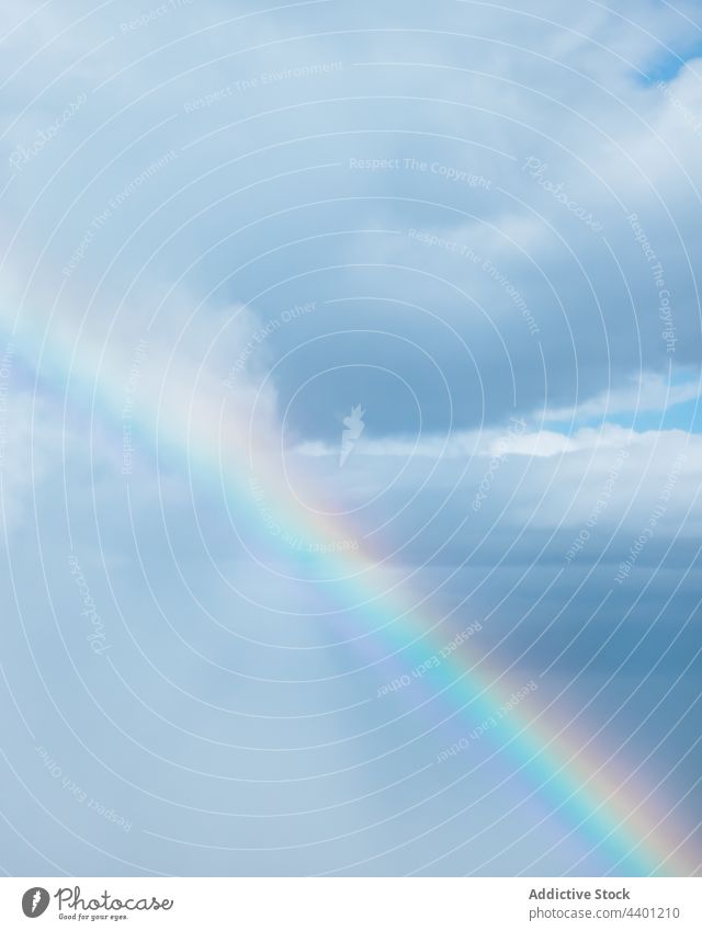 Rainbow in blue cloudy sky rainbow blue sky phenomenon colorful scenic heaven natural nature environment transparent translucent weather tranquil peaceful