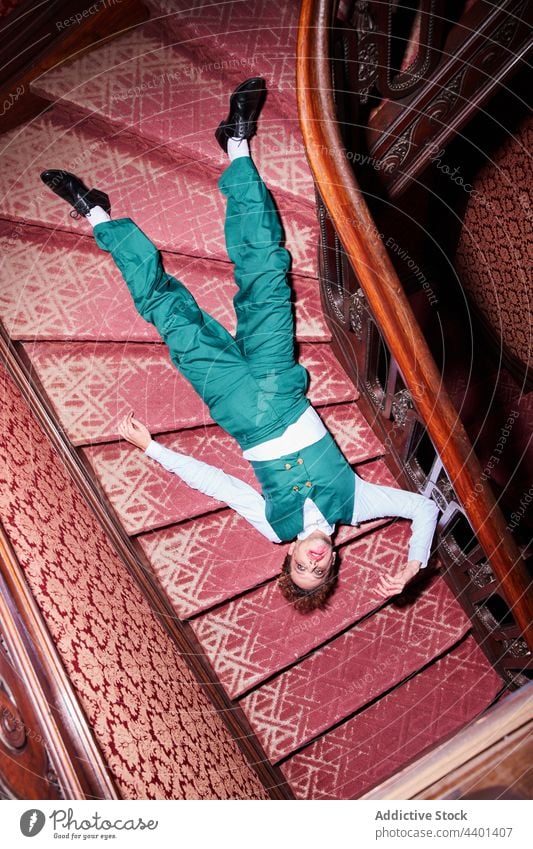 Male actor pretending being dead man death perform expressive dramatic lying stair male show eccentric play art skill talent creative artist fantasy inspiration