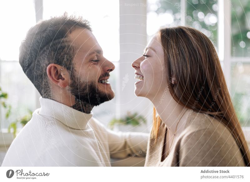 Dreamy woman smiling bearded husband at home couple embrace caress love relationship romantic dreamy tattoo portrait wife friendly sincere contemplate