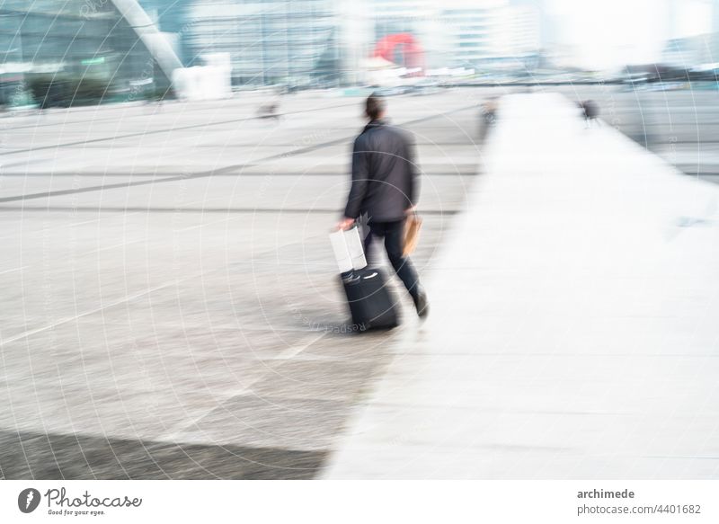 People walking in the city travel commute man baggage luggage business businessman financial district paris commuting commuter urban horizontal copy space