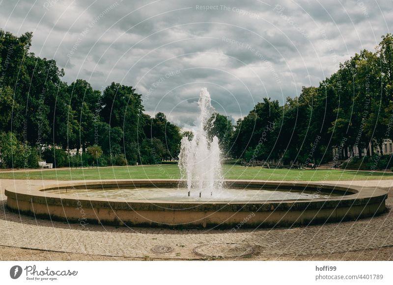 round fountain in the park Fountain Park Water fountain Well Drops of water Water fountains Clouds Clouds in the sky Inject Sunlight Wet Fresh Movement Bubbling