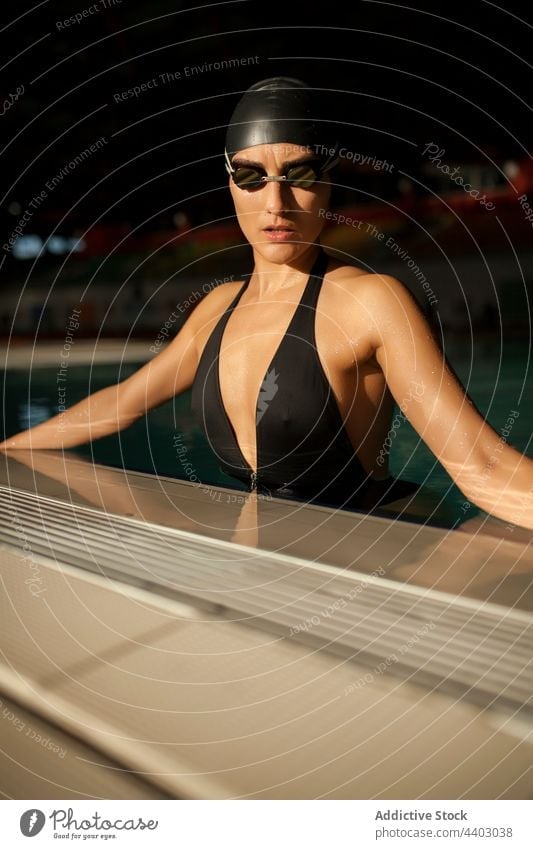 Woman swimmer in the pool woman sportswoman clothing middle model down standing competition face swimsuit dedication beautiful closeup black swimming lifestyle