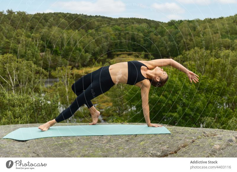 Fit woman doing Camatkarasana pose in lush nature yoga grace stretch balance summer wild thing pose practice slim female session young harmony fit peaceful