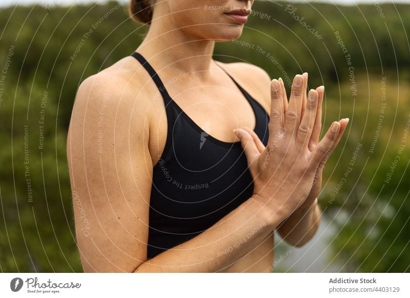 Concentrated woman meditating with praying hands outdoors meditate yoga concentrate stress relief zen harmony portrait practice wellness vitality