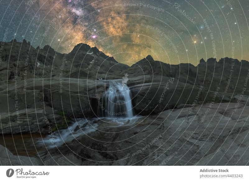 Waterfall in mountains under sunset sky with Milky Way waterfall milky way starry nature astronomy space river highland foamy cascade flow galaxy universe