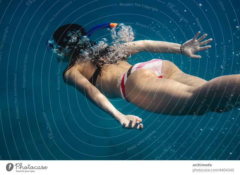Woman diving into the ocean dive snorkeling sea swim swimming vacation freedom blue water lifestyle wave underwater adventure nature travel woman young wild