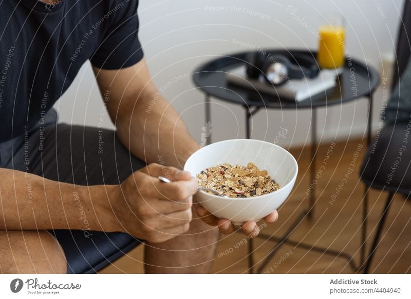 Crop man eating granola for breakfast muesli morning bowl food healthy home male meal nutrition fresh ingredient healthy food oat tasty delicious at home