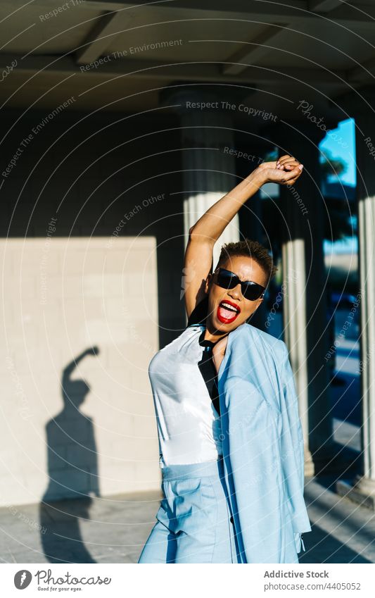 Happy black woman in trendy clothes in town fashion style having fun individuality sunglasses energy happy stylish stand mouth opened cheerful smile content