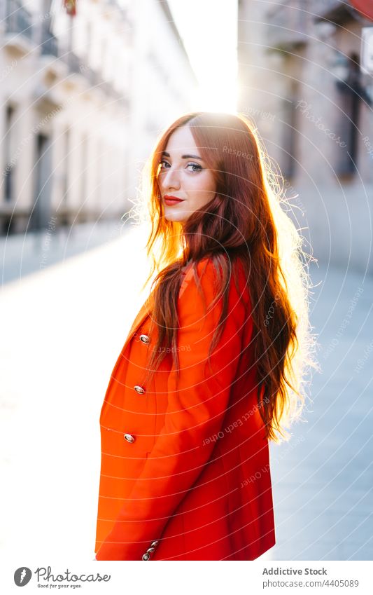 Trendy redhead woman in suit in city orange vivid street style trendy female outfit confident urban fashion building modern model contemporary personality