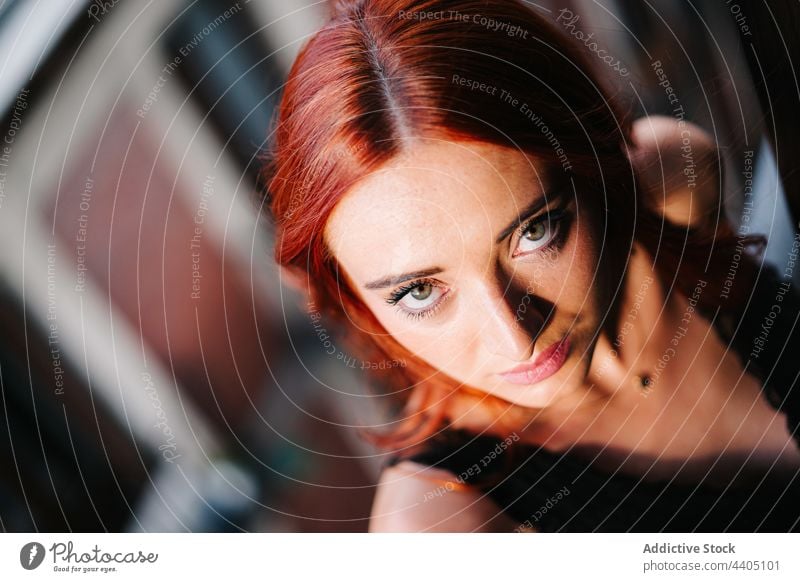 Charming redhead woman looking at camera red hair charming appearance balcony serene calm peaceful complexion female tranquil gentle green eyes harmony