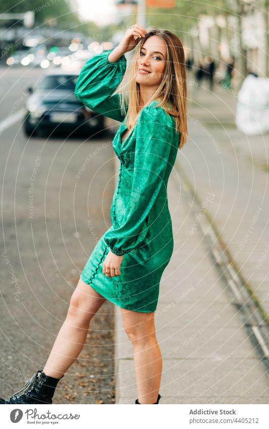 Happy woman in stylish green dress in city trendy fashion style outstretch carefree freedom female outfit summer urban charming street smile enjoy feminine