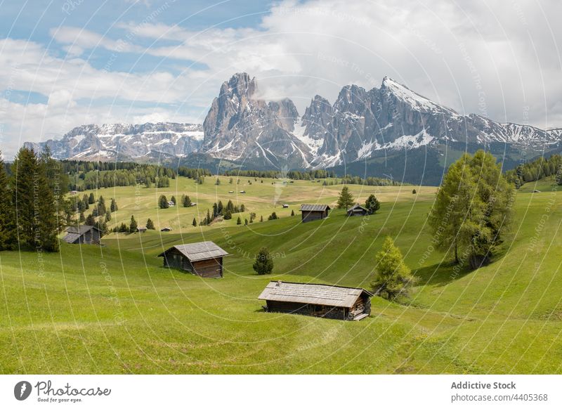 Mountainous village in green valley on sunny day mountain highland meadow alpine settlement house landscape scenery dolomite italy alps seiser alm summer