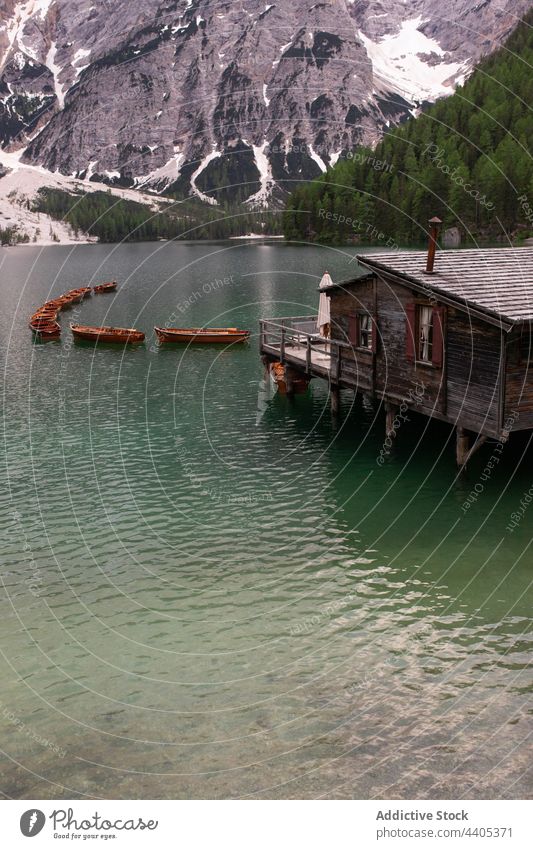 Boats and wooden pier on lake in mountains boat landscape float pond highland dock lake braies pragser wildsee dolomite italy alps water nature scenery peaceful