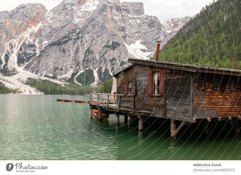 Boats and wooden pier on lake in mountains boat landscape float pond highland dock lake braies pragser wildsee dolomite italy alps water nature scenery peaceful