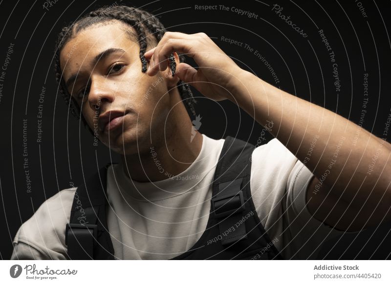 Stylish black man with braids style fashion afro outfit model confident contrast dark male ethnic african american appearance young serious self assured