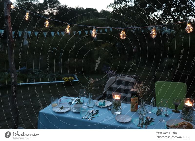 set garden table in dusky evening mood lampions Fairy lights Summer Firm Garden festival at the same time in common Together Summer evening Lamp