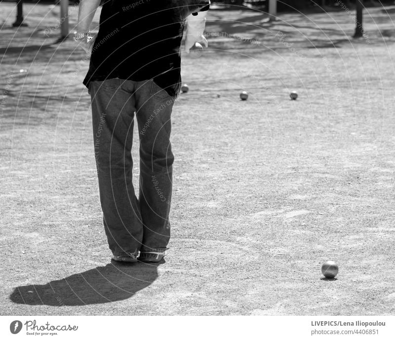 Rear view of a person throwing the bowl during a competition achievement backgrounds ball bocce body part bowls city classic cochonnet collective game