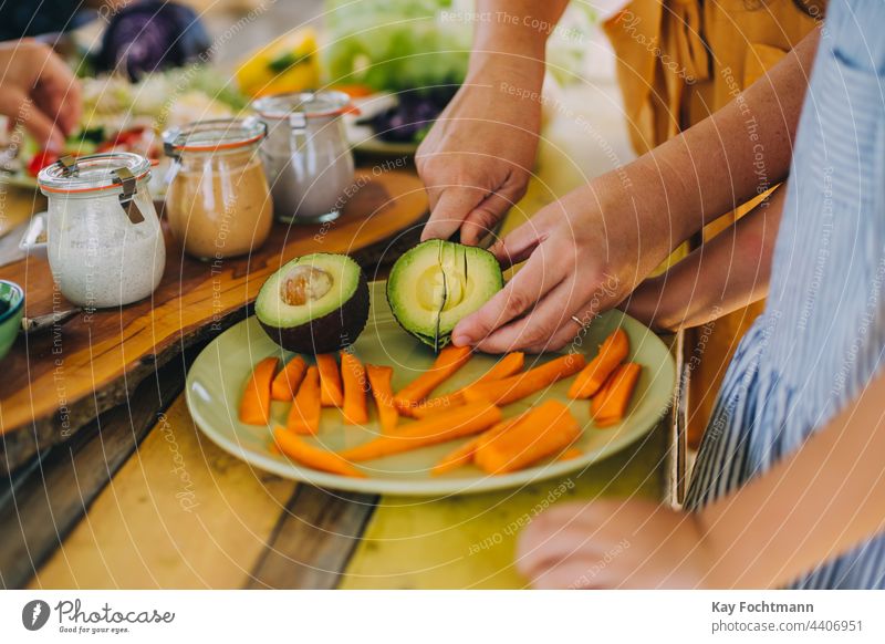 image of hands cutting an avocado background beauty board bowl care carrots closeup concept cook cooking crystal cutting board diet dieting face facial female