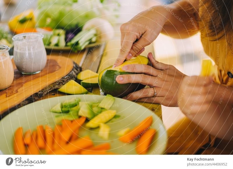 photo of woman preparing a mango appetizer carrot close-up closeup cut cutting delicious dieting dinner dish exotic food food and drink fresh freshness fruit