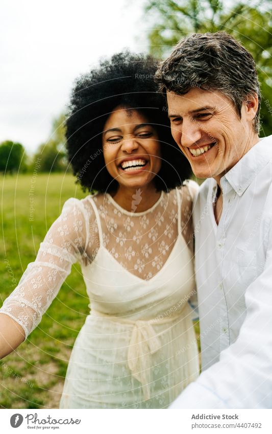 Multiethnic couple caressing horse in countryside stroke pasture together meadow field summer multiethnic multiracial diverse black african american love green