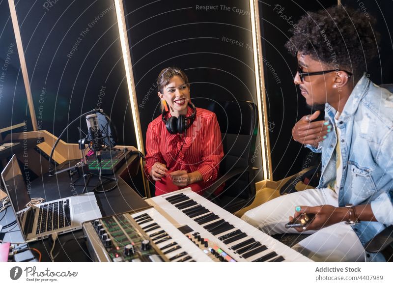 Multiracial colleagues recording music in studio musician together microphone song sing singer multiracial multiethnic diverse black african american sound