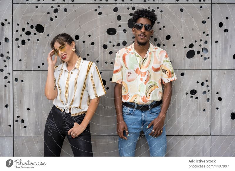 Stylish diverse models standing near wall in city fashion together street art creative trendy style multiracial multiethnic black african american modern