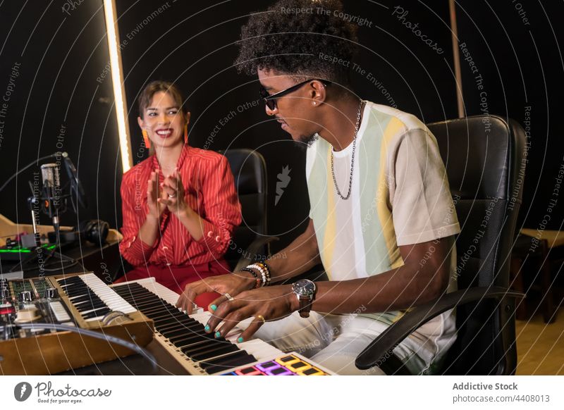 Multiracial colleagues recording music in studio musician together microphone song sing singer multiracial multiethnic diverse black african american sound
