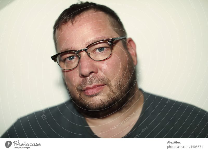Close portrait of a man with glasses and 3 days beard Man Facial hair 3-days-beard unostentatious gut Athletic good-looking Reliability Photographer inside